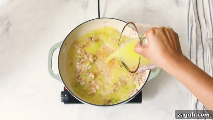 Creamy Tomato Bisque Recipe: Smooth, Rich, and Quick to Make 7 Broth in a pot with sauteed vegetables