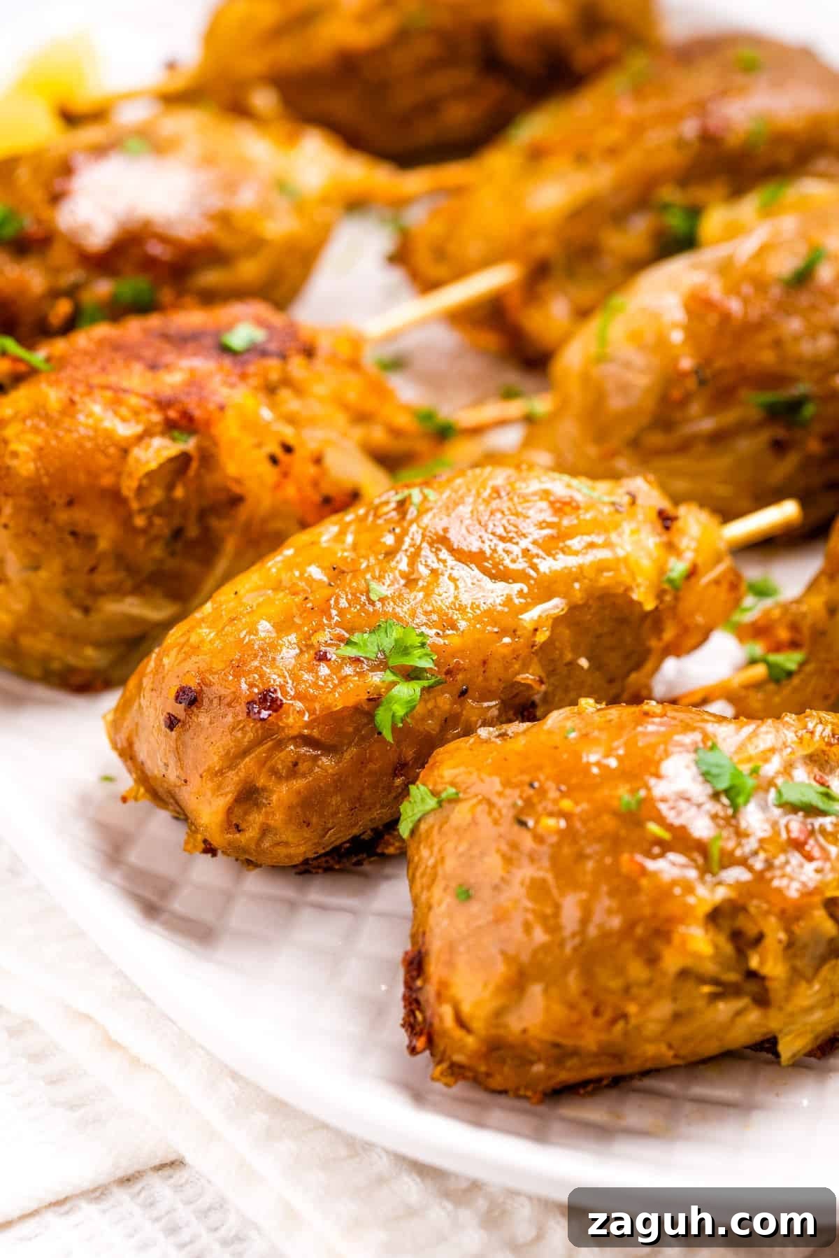 Close up view of vegan drumsticks on a white plate. 