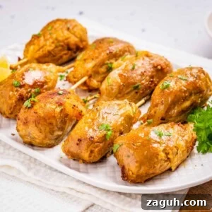 Overhead view of cooked vegan drumsticks on a white plate.