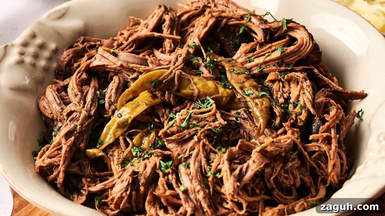17 Show-Stopping Potluck Recipes That Steal the Spotlight 14 A bowl of shredded beef garnished with cilantro and peppers.