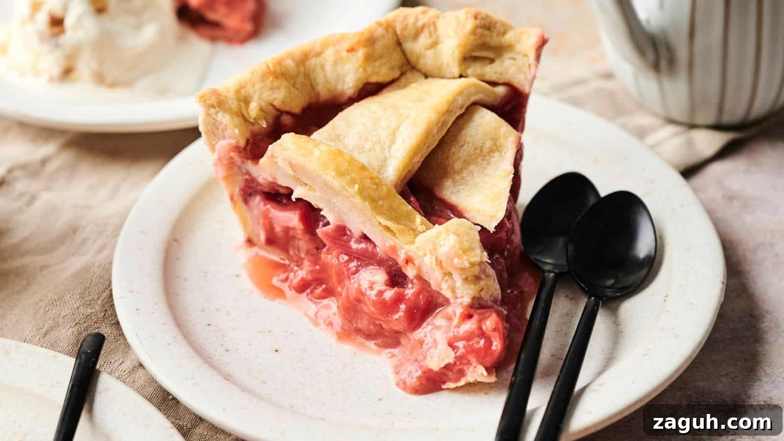 17 Show-Stopping Potluck Recipes That Steal the Spotlight 7 Slice of strawberry pie on a plate with two black spoons beside it.