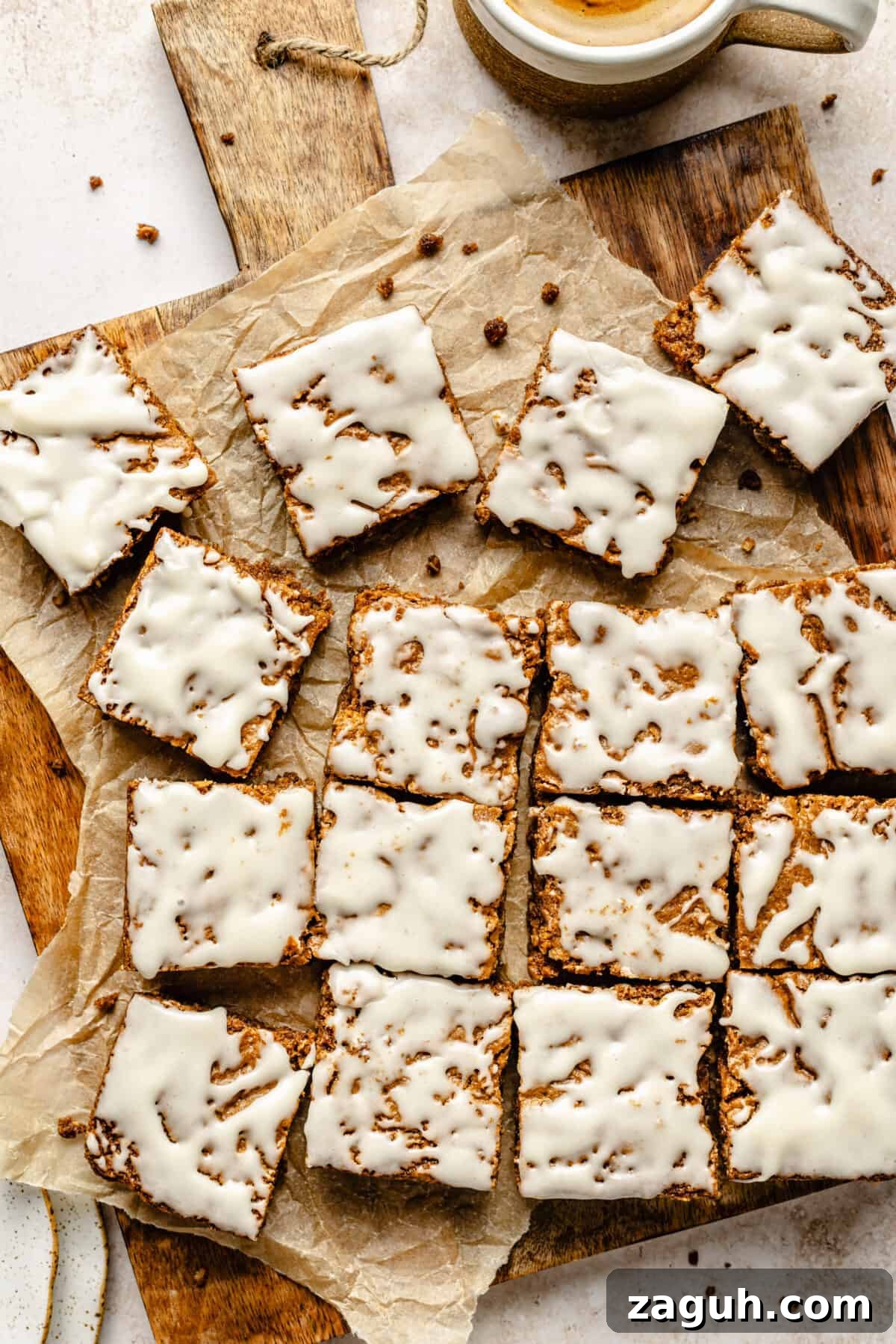 Iced Oatmeal Cookie Bars sliced on wooden board.