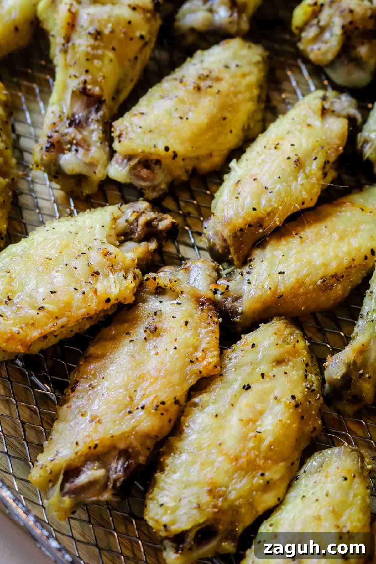 Crispy Baked Salt-and-Pepper Chicken Wings Recipe 8 baked chicken wings on crisper tray.