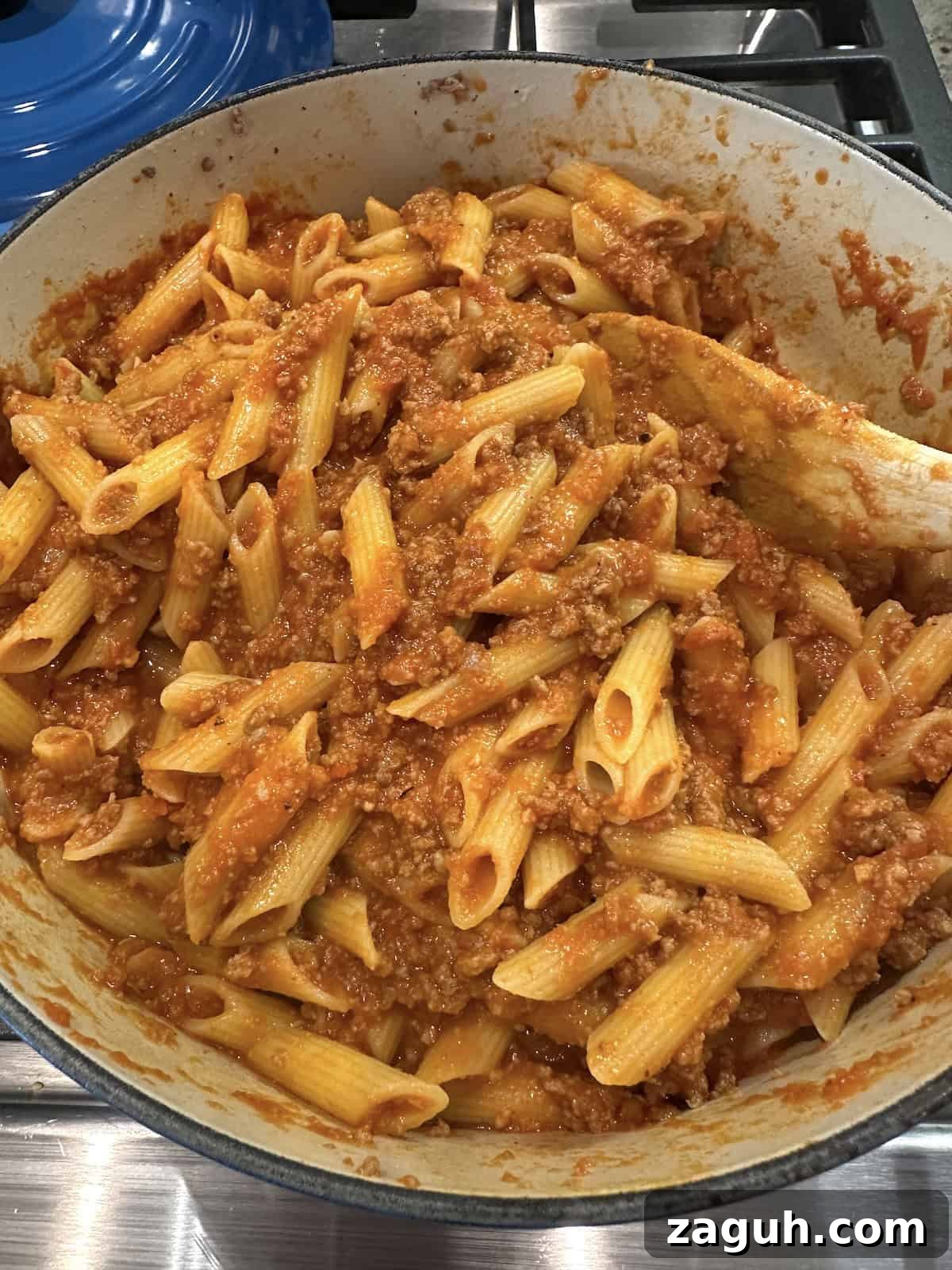 Quick No-Fuss Lasagna Recipe for Busy Weeknights 6 Pasta, meat and sauce for lazy lasagna in a pot on the stove.