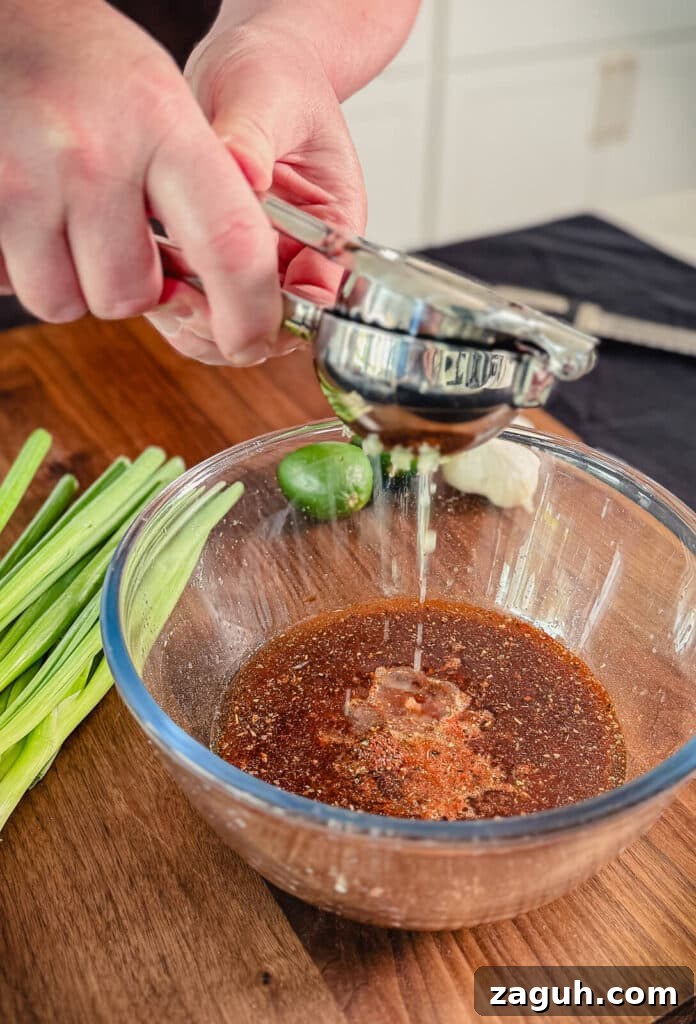 Peruvian-Style Chicken Breast Skewers with Aji Marinade 8 Lime juice being squeezed into a Peruvian marinade