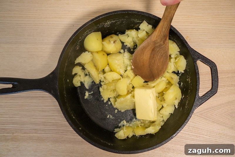 Rustic Buttermilk Mashed Potatoes Without a Masher 5 Adding the butter to the potatoes