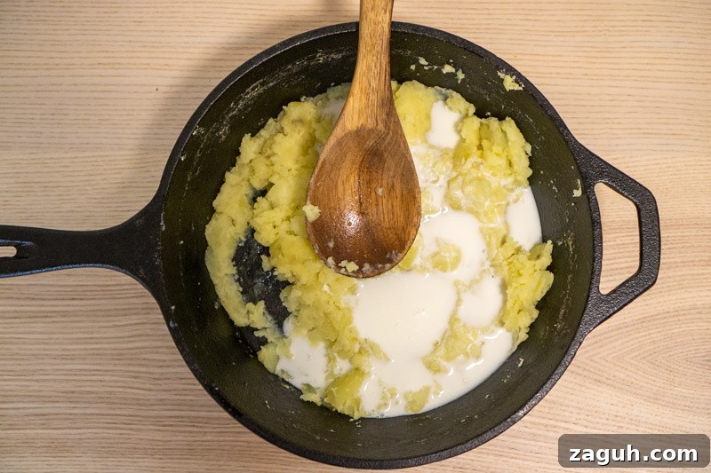Rustic Buttermilk Mashed Potatoes Without a Masher 6 Adding the milk and buttermilk to the potatoes