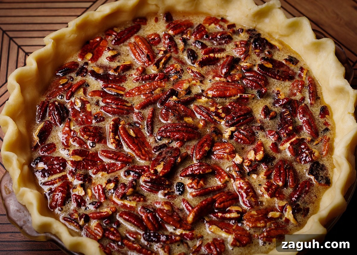 Pecan Pie Made Without Corn Syrup — Classic Recipe with Pure Maple 13 An unbaked pecan pie that's ready to go into the oven.