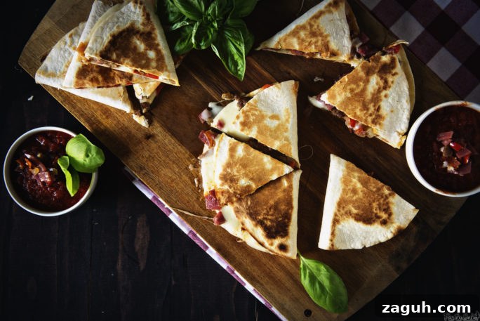 Loaded Meat Lovers Quesadilla Recipe for Carnivores 2 This quesadilla is all cut up and ready to go. Meat and cheese spilling out everywhere. Grab a slice, and a napkin!
