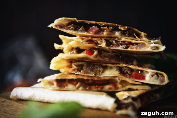 Loaded Meat Lovers Quesadilla Recipe for Carnivores 5 A stack of meat filled quesadilla slices. So much meat!