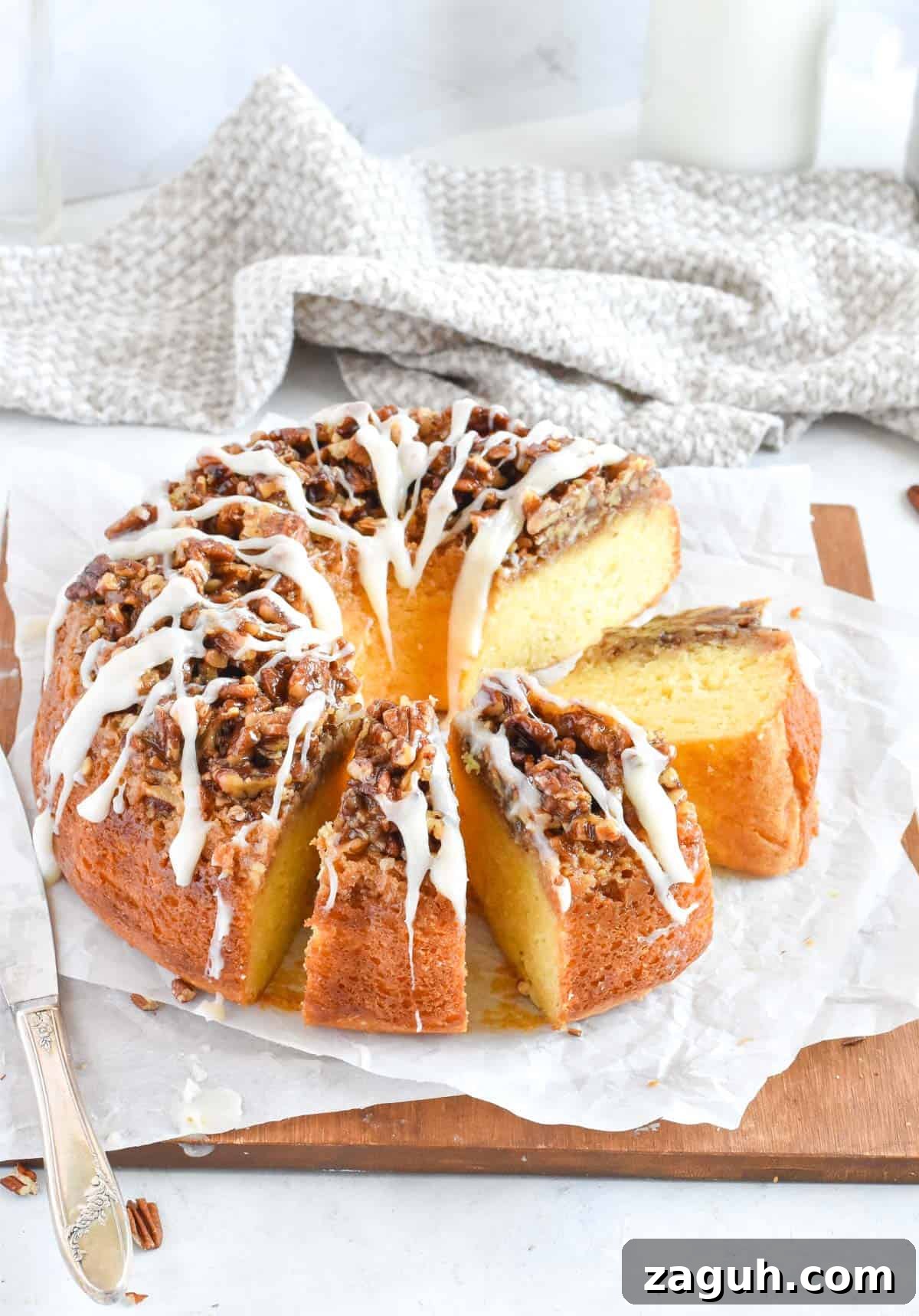 Sticky Pecan Upside-Down Cake Recipe for Moist, Caramelized Dessert 2 cake sliced up on wooden board.