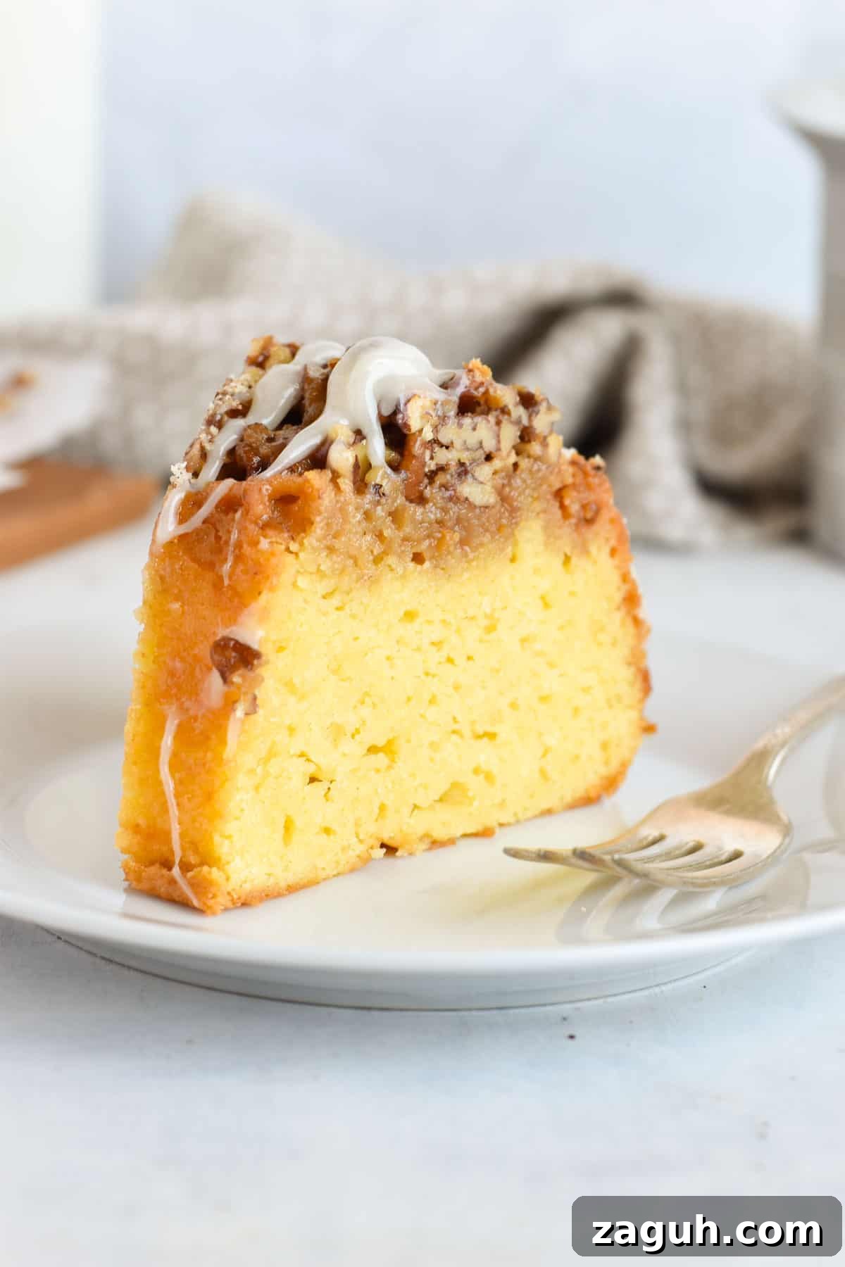 Sticky Pecan Upside-Down Cake Recipe for Moist, Caramelized Dessert 7 slice of cake on white plate.
