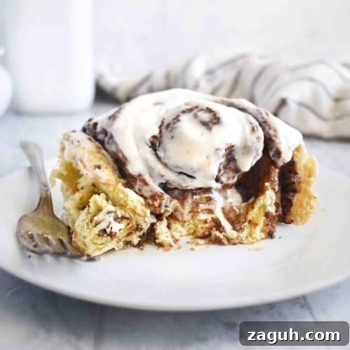half eaten cinnamon roll on plate