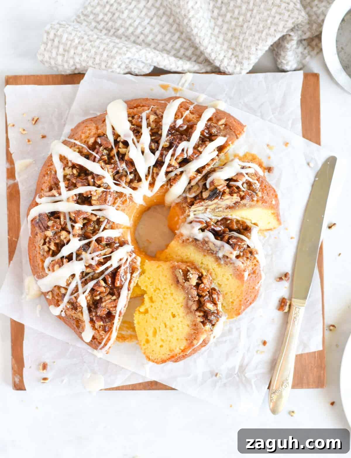 Sticky Pecan Upside-Down Cake Recipe for Moist, Caramelized Dessert 6 sliced up cake with knife on side.