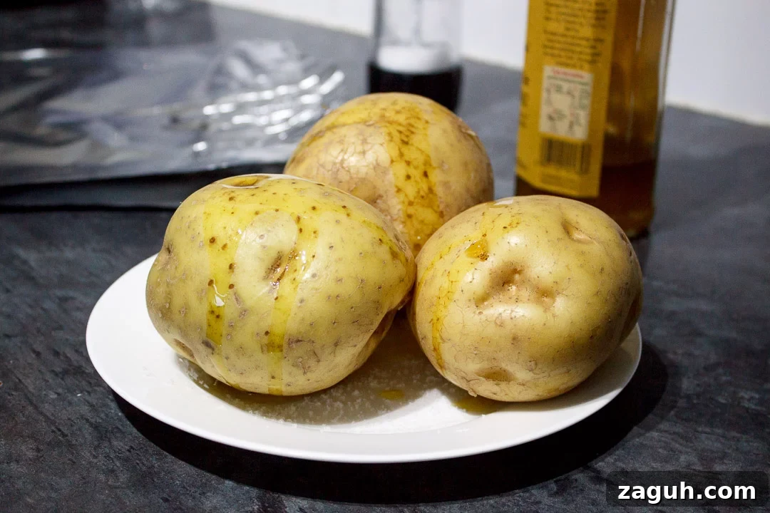 Slow Cooker Jacket Potatoes: Creamy Baked Potatoes Made Ahead 12 3 baking potatoes on a plate with salt, drizzled with oil