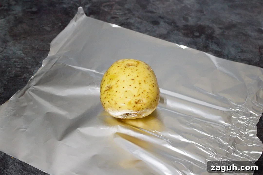 Slow Cooker Jacket Potatoes: Creamy Baked Potatoes Made Ahead 13 a jacket potato wrapped in tin foil