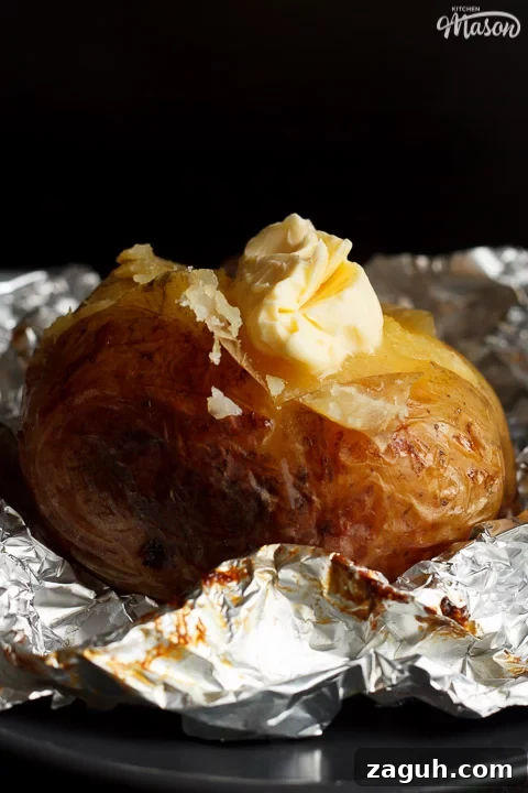 Slow Cooker Jacket Potatoes: Creamy Baked Potatoes Made Ahead 16 A slow cooker jacket potato on foil topped with melting vegan butter