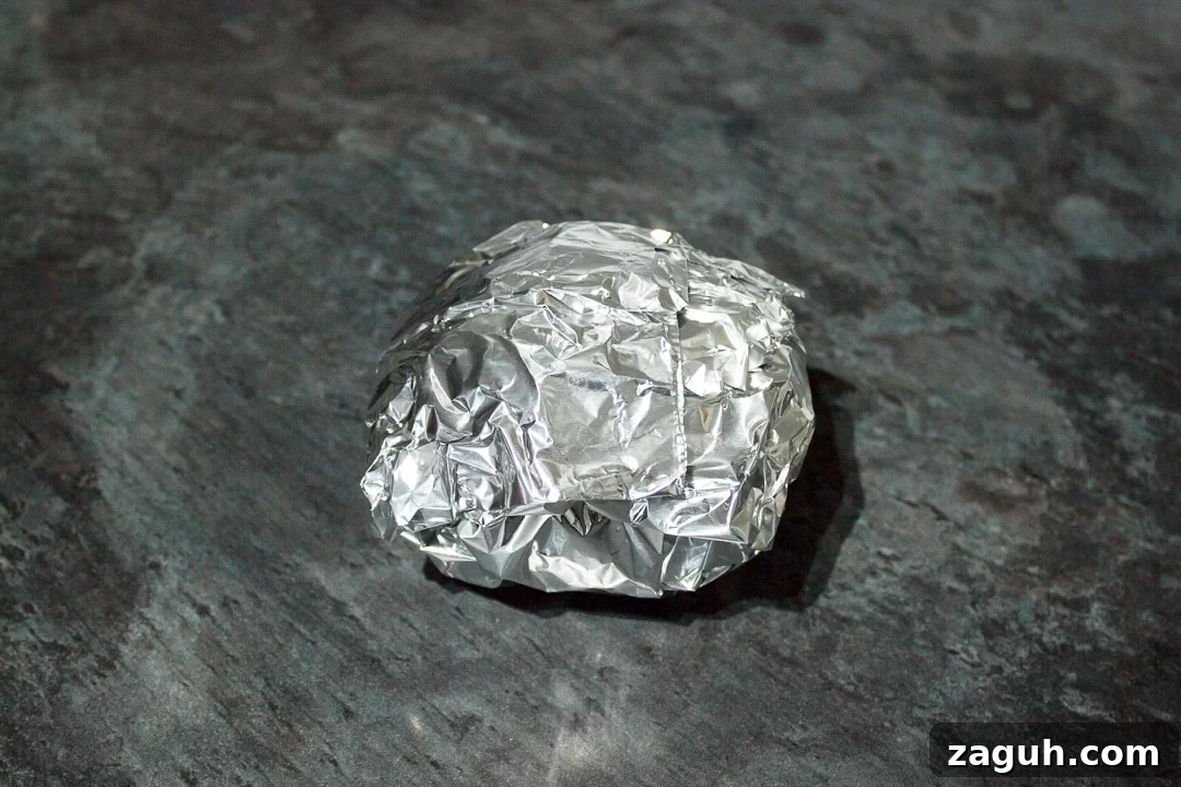 Slow Cooker Jacket Potatoes: Creamy Baked Potatoes Made Ahead 21 a jacket potato wrapped in tin foil