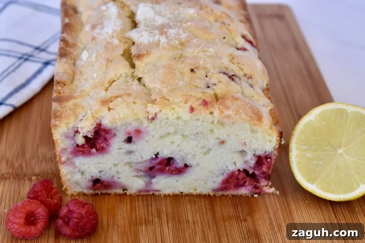 Lemon Raspberry Ricotta Loaf Cake Recipe 7 Lemon Raspberry Loaf Cake on a cutting board.