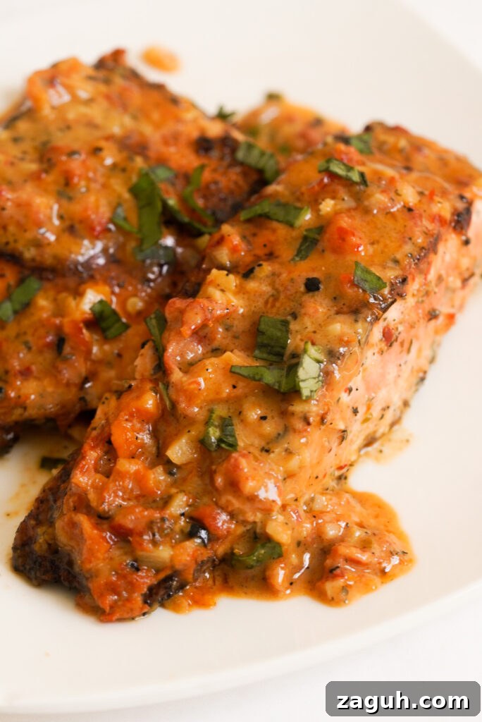 Marry Me Salmon Recipe: Creamy Garlic Butter Salmon You'll Love 15 creamy marry me salmon on a white plate.