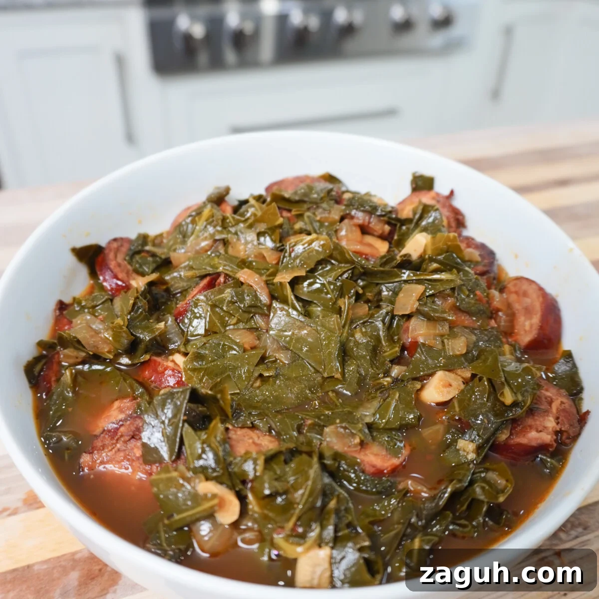 Savory Sausage and Slow-Simmered Collard Greens Recipe 2 Collard Greens and Sausage plated in a white bowl.