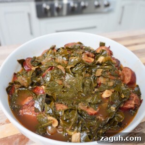 Savory Sausage and Slow-Simmered Collard Greens Recipe 12 Collard Greens and Sausage plated in a white bowl.