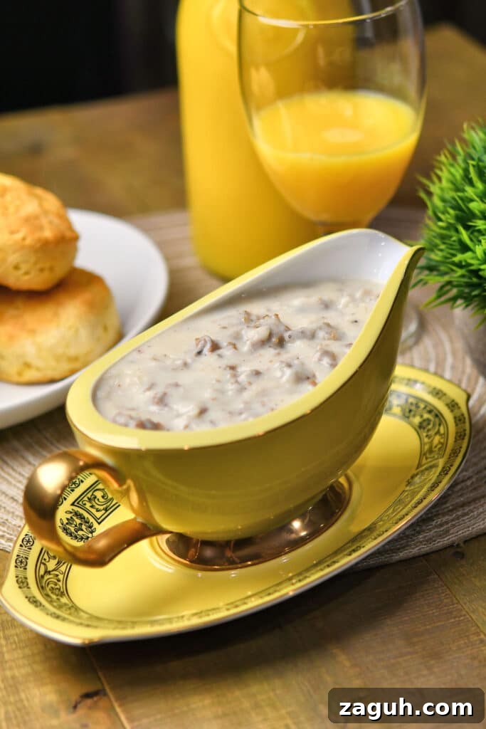 Southern Sausage Gravy Recipe with Biscuits — Classic Comfort Food 5 sausage gravy in a vintage gravy boat