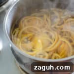 Boiling the orange peel strips before crystallising