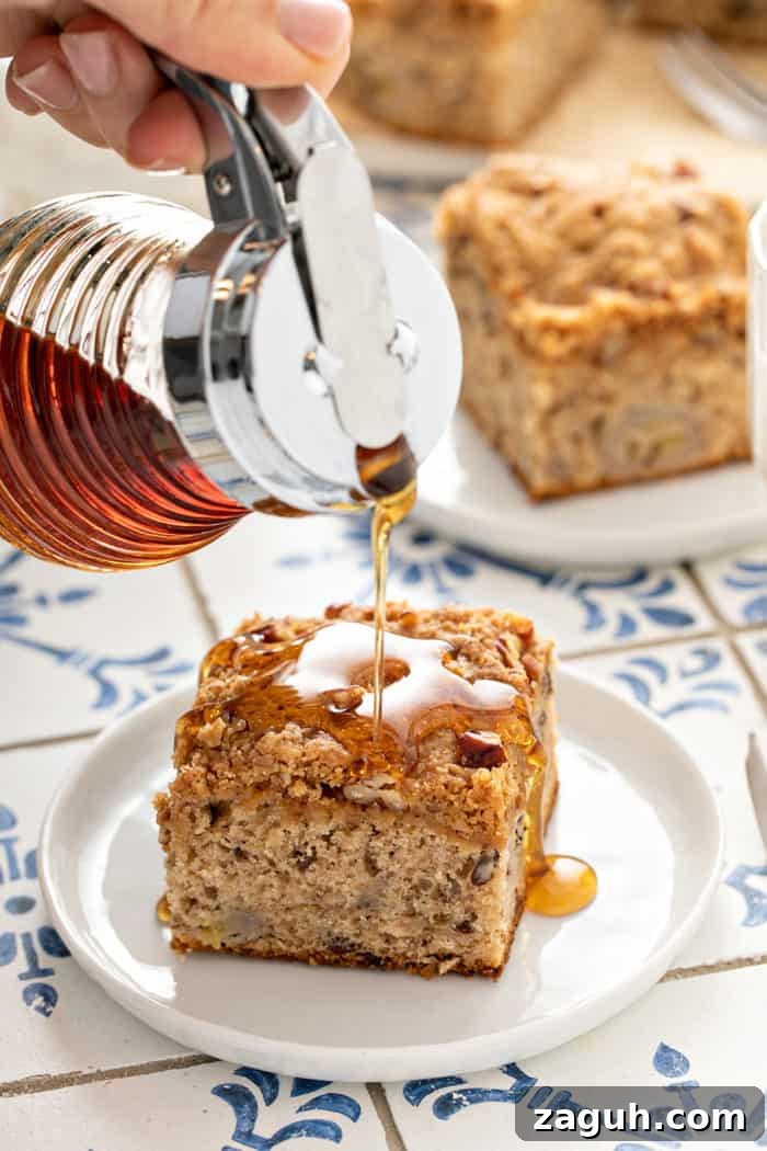 Make-Ahead Banana Coffee Cake Recipe for Perfect Morning Baking 2 Maple syrup being poured over the top of a slice of banana coffee cake