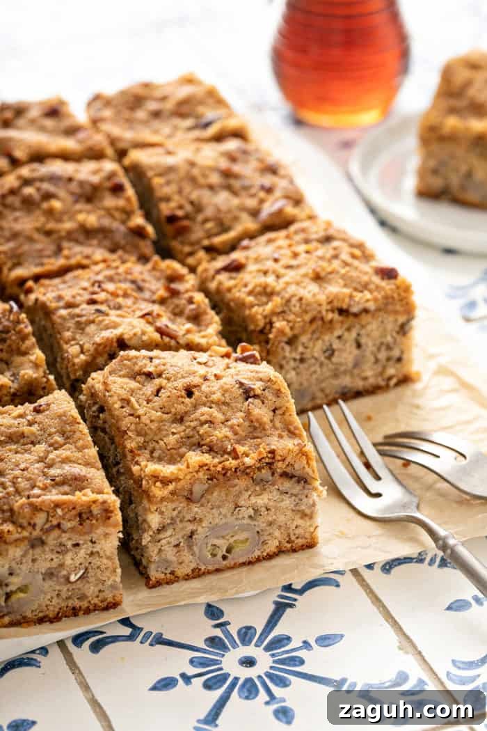 Make-Ahead Banana Coffee Cake Recipe for Perfect Morning Baking 9 Slices of banana coffee cake set on a piece of parchment paper next to two forks