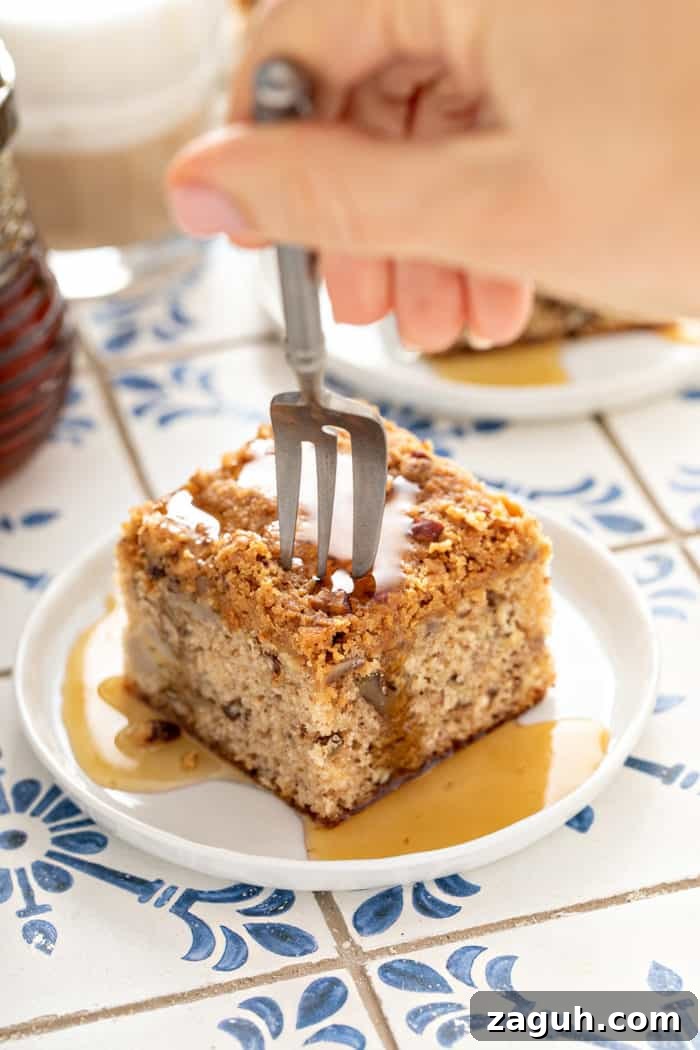 Make-Ahead Banana Coffee Cake Recipe for Perfect Morning Baking 10 Fork about to take a bite from a plated slice of banana coffee cake