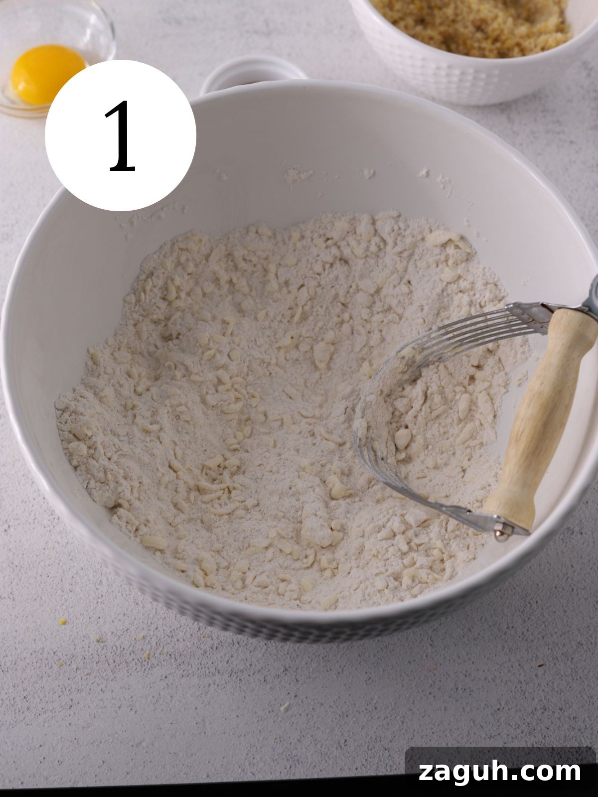 Flaky Strawberry Scones with Glaze — Homemade Recipe 4 Bowl with dry ingredients and butter being cut in.