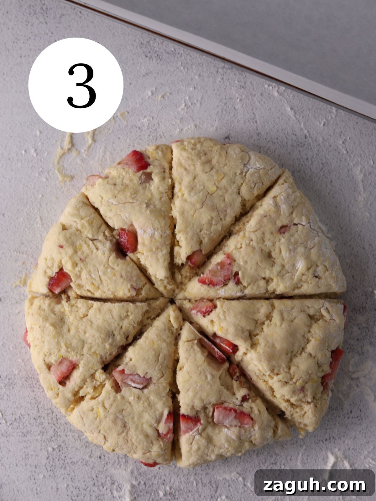 Flaky Strawberry Scones with Glaze — Homemade Recipe 6 Strawberry scones dough formed into a circle and sliced into triangles.