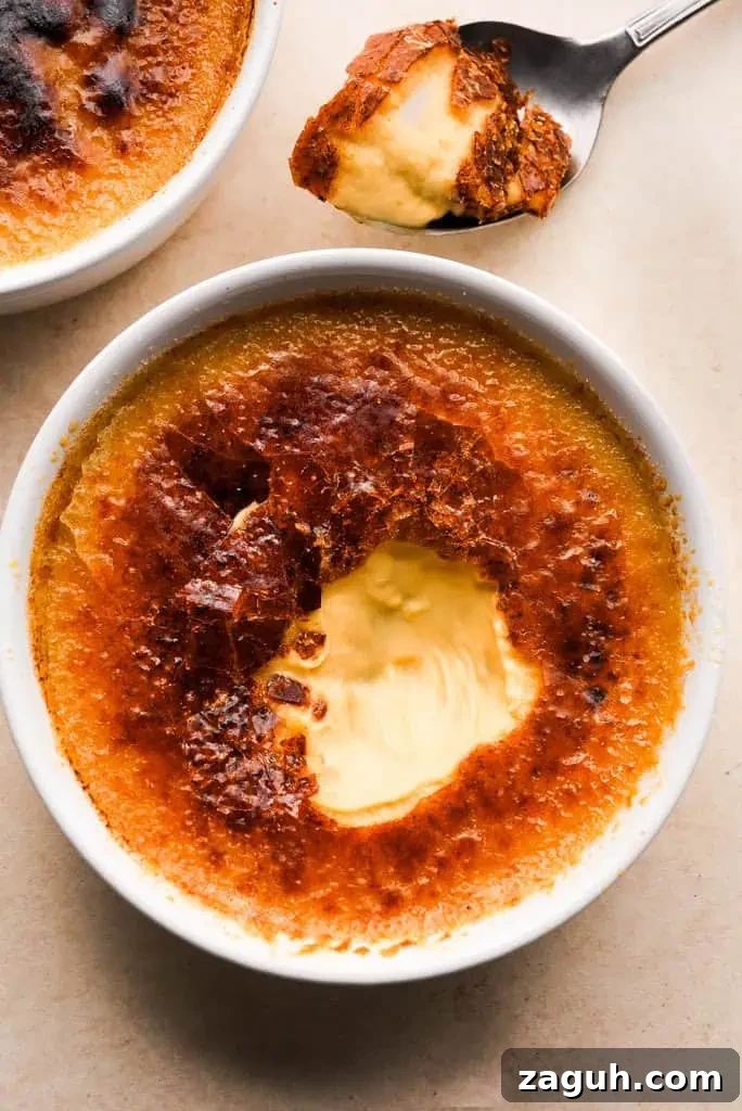 fall creme brulee Pumpkin creme brulee with a caramelized top, partially eaten to reveal the creamy pumpkin custard inside.