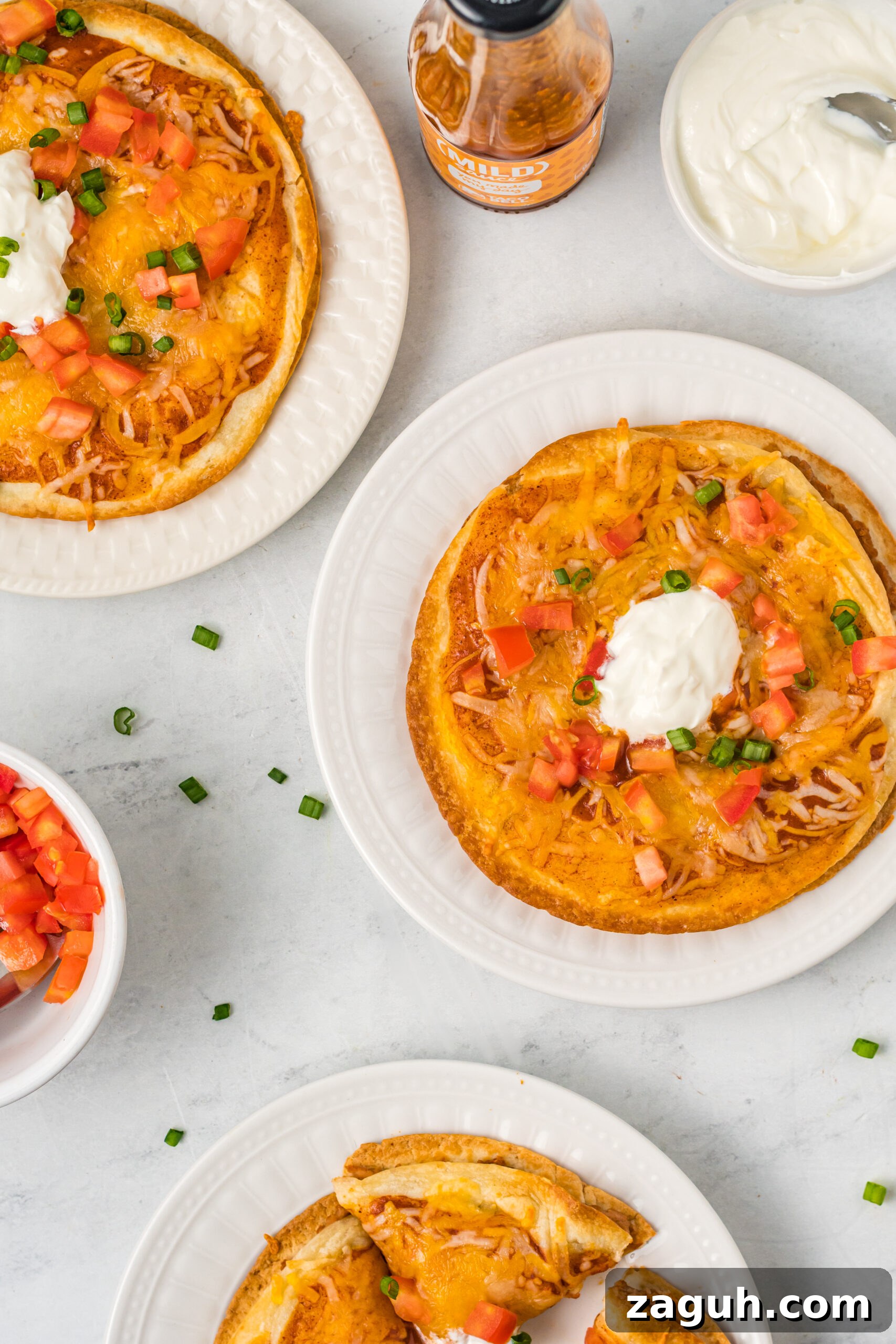 Taco Bell Mexican Pizza: How to Order, Ingredients & Nutrition Facts 11 Overhead shot of three Mexican pizzas on white plates.