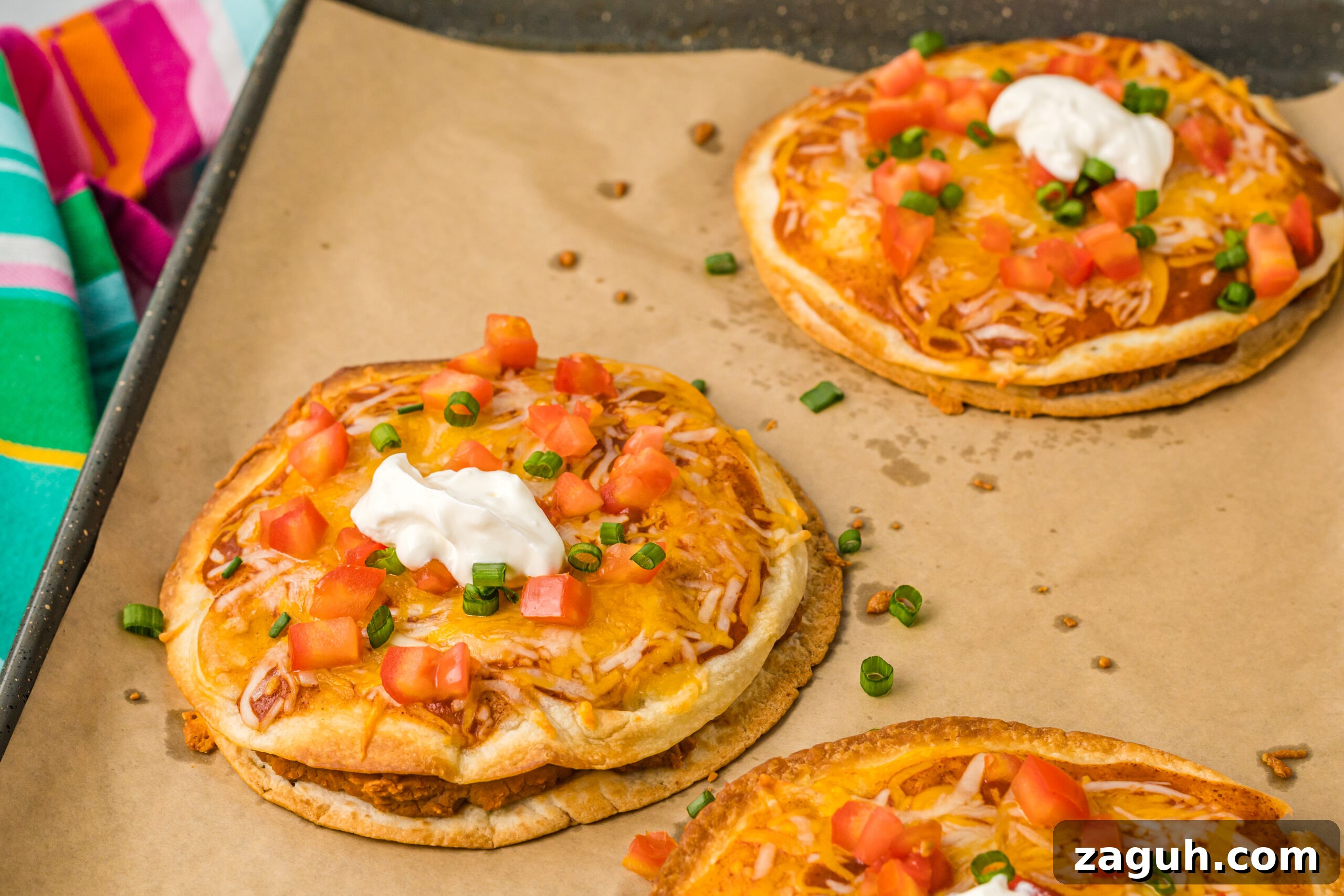 Taco Bell Mexican Pizza: How to Order, Ingredients & Nutrition Facts 10 three mexican pizzas on brown paper lining a baking sheet