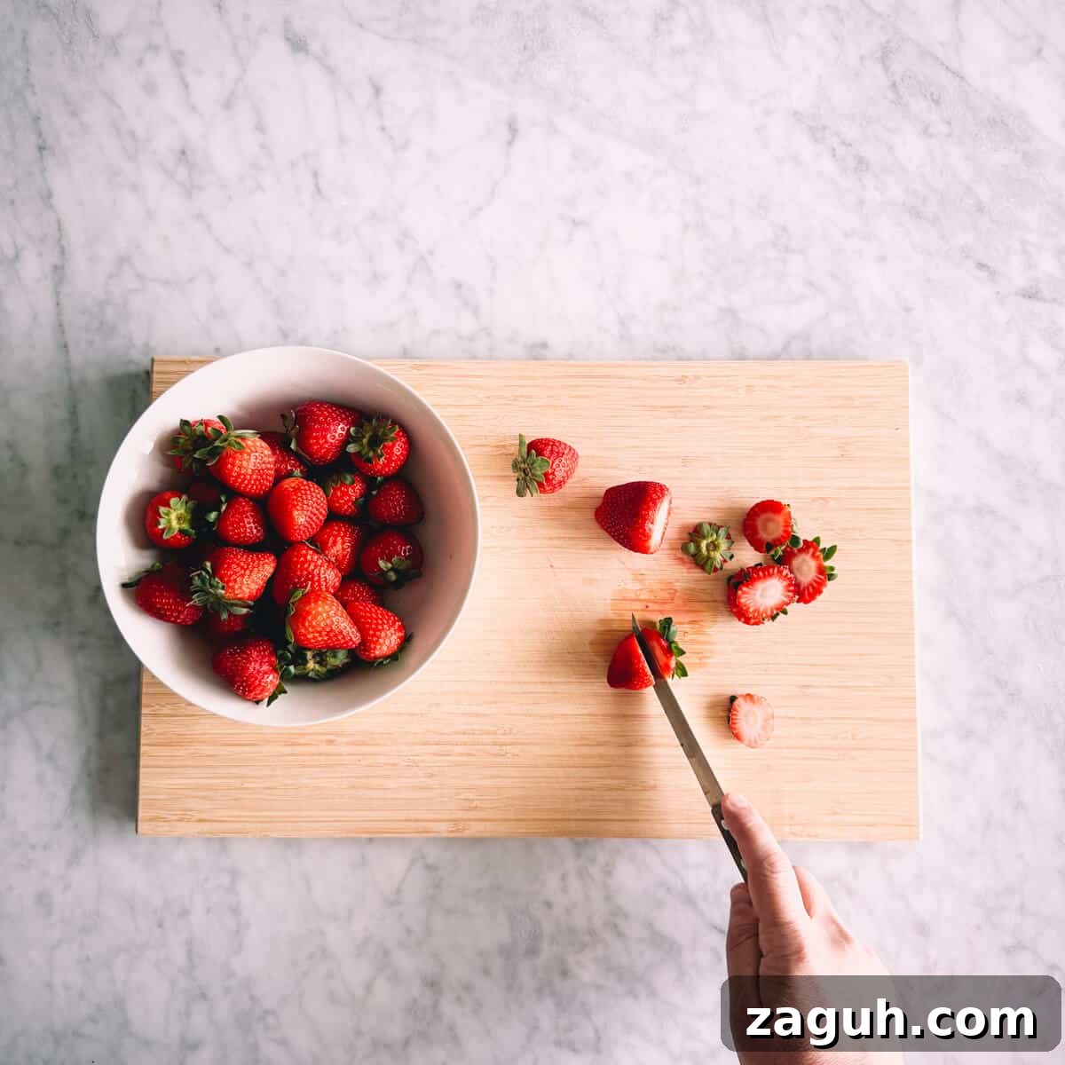 Strawberry Greek Yogurt Popsicles Recipe — Creamy Frozen Treats 4 chopping strawberries on a chopping board.