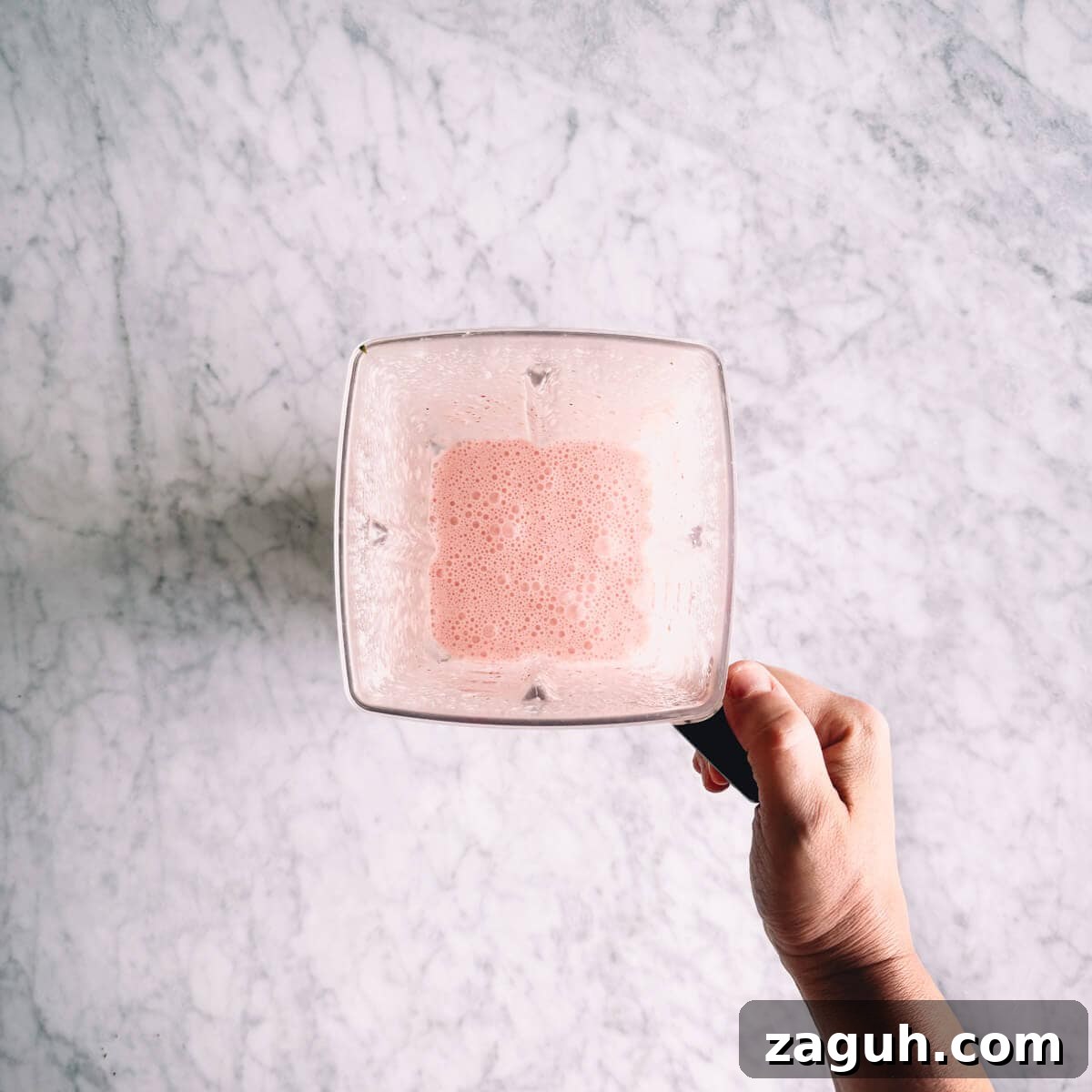 Strawberry Greek Yogurt Popsicles Recipe — Creamy Frozen Treats 6 strawberry popsicle mixture blended in a blender.