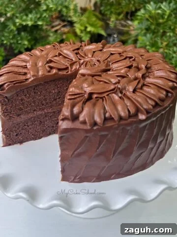Sliced Brownie Cake on a white cake pedestal.