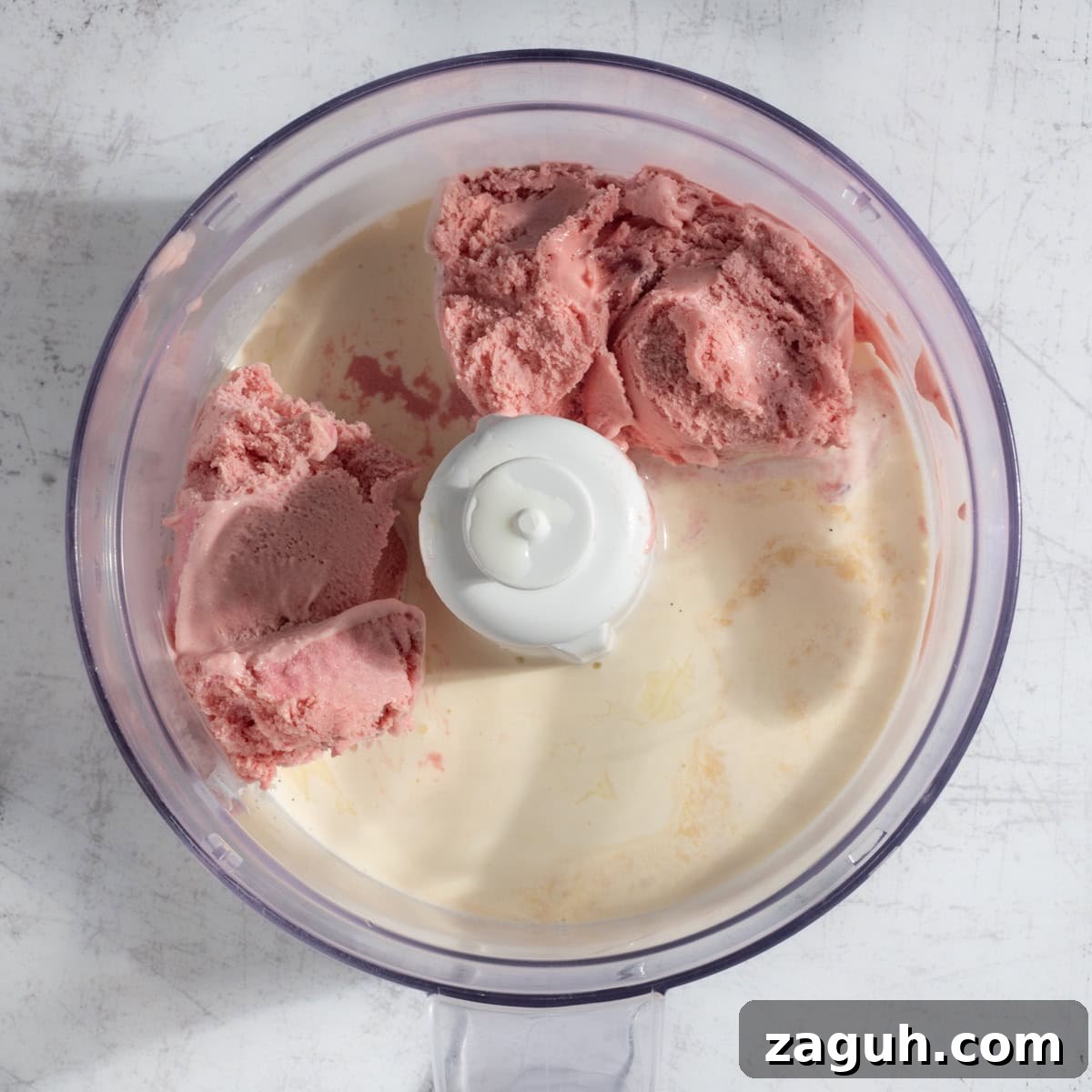 Creamy Strawberry Ice Cream Milkshake with a Secret Twist 8 Adding all the ingredients for strawberry milkshake with ice cream in a blender.