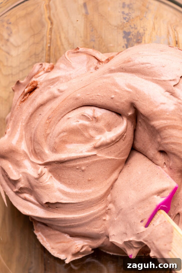 Decadent Chocolate Mousse Cake Recipe for Chocolate Lovers 10 Chocolate whipped cream in a bowl.