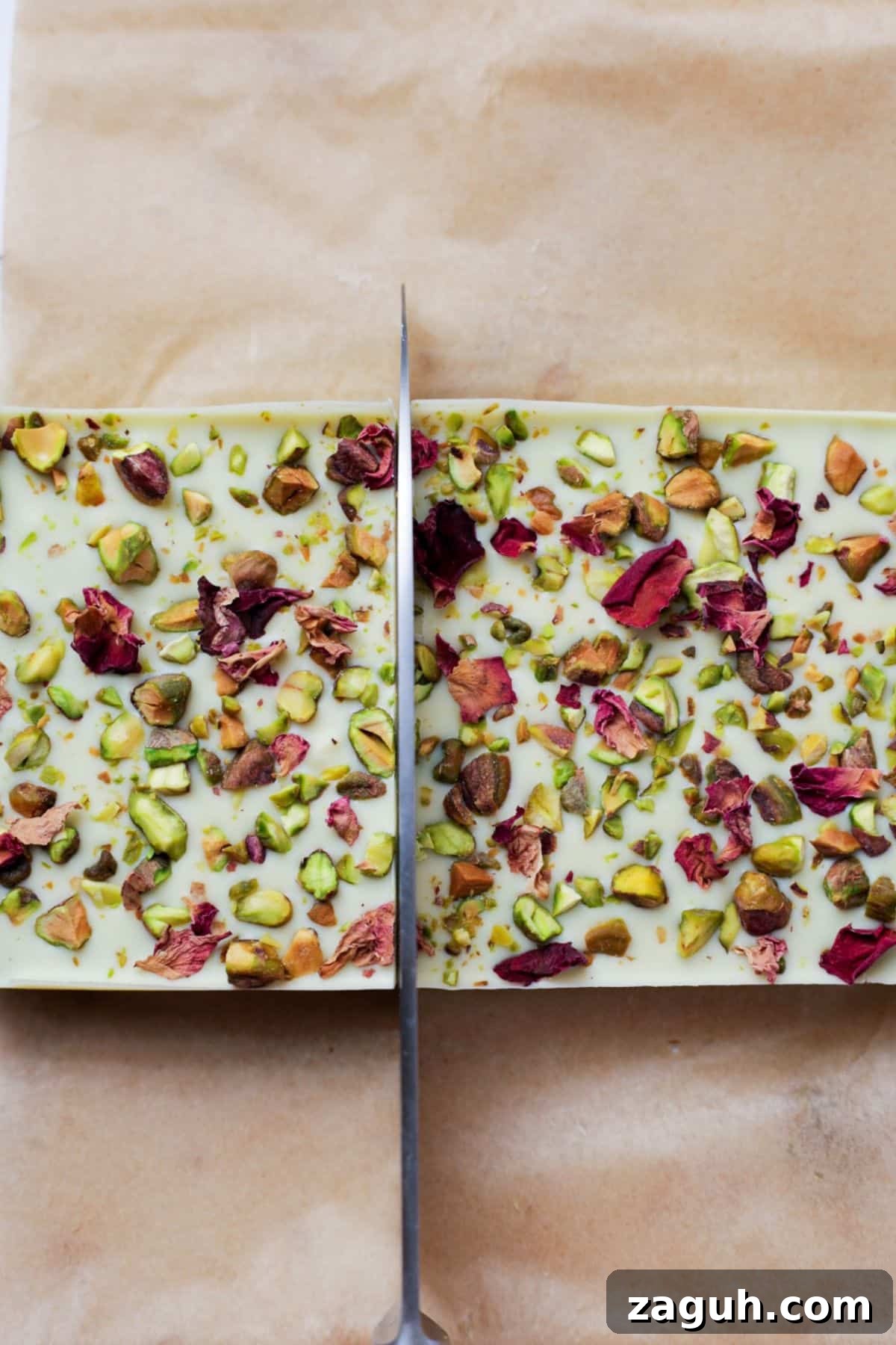 Homemade Pistachio Protein Bars Recipe for High-Energy Snacks 9 Large knife cutting through white chocolate topped pistachio bars in loaf pan