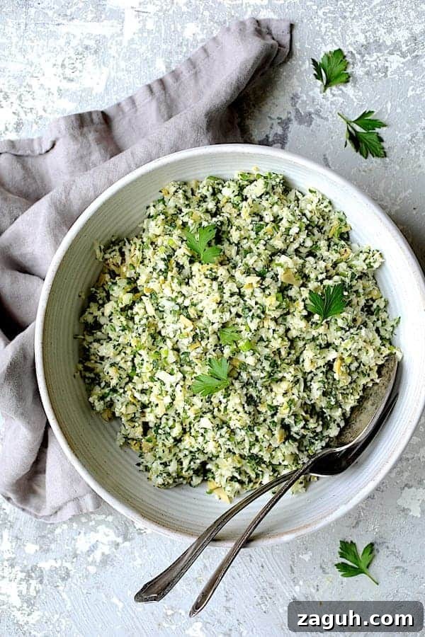 Cauliflower & Artichoke Tabbouleh: Fresh Low-Carb Salad Recipe 2 Photo of Cauliflower Artichoke Tabbouleh in white bowl on light gray background with light gray napkin.
