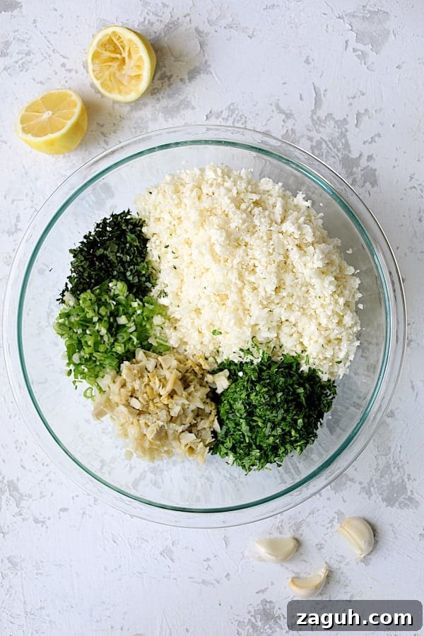 Cauliflower & Artichoke Tabbouleh: Fresh Low-Carb Salad Recipe 3 Photo of ingredients for Cauliflower Artichoke Tabbouleh ingredients in glass bowl before being stirred together.