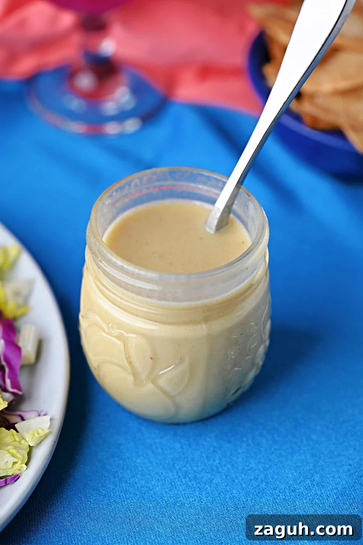 Zesty Honey-Lime Salad Dressing Recipe for Fresh Greens 10 Small jar of honey lime dressing with a spoon ready to use.