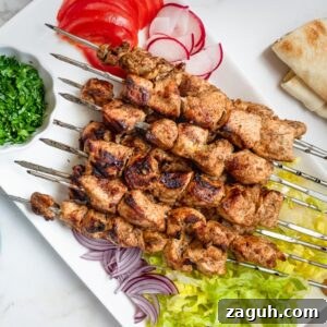 Chicken Shawarma Kebabs Recipe: Juicy Grilled Middle Eastern Skewers 8 Platter of chicken shawarma skewers.