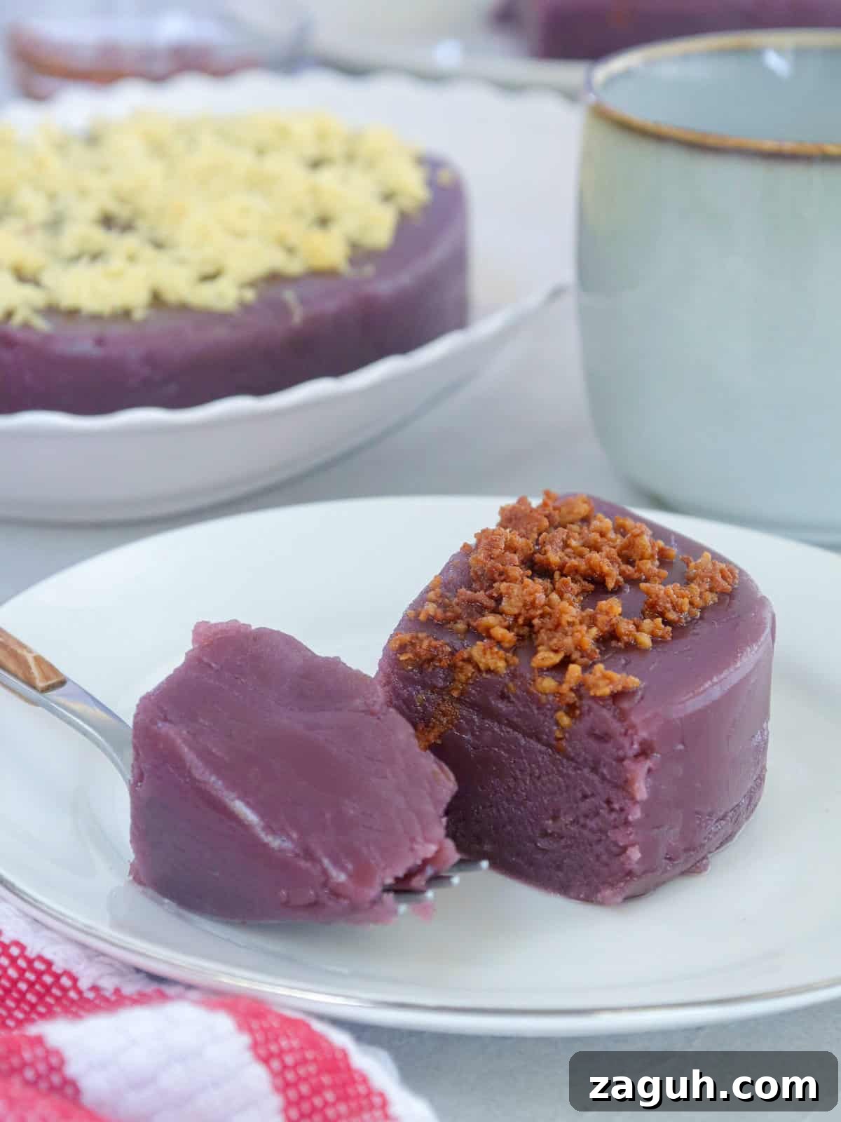 Ube Halaya Recipe: How to Make Creamy Filipino Purple Yam Dessert 5 slice of ube halaya with latik topping on a white serving plate.