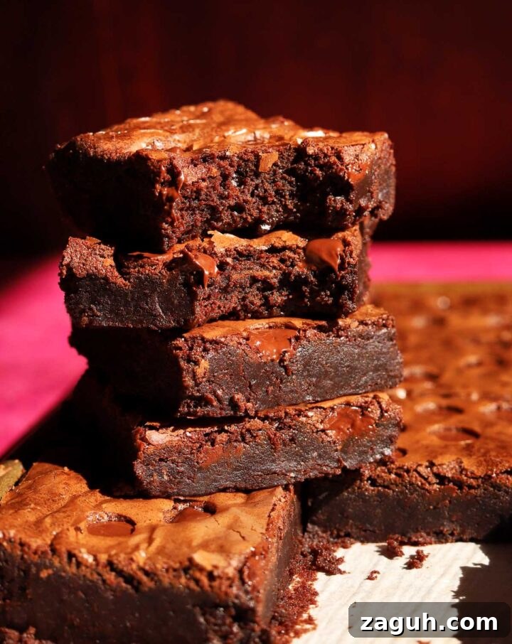 Chewy Sheet-Pan Brownies: One-Pan Recipe for Fudgy Bars 6 stack of sheet pan brownies with bite