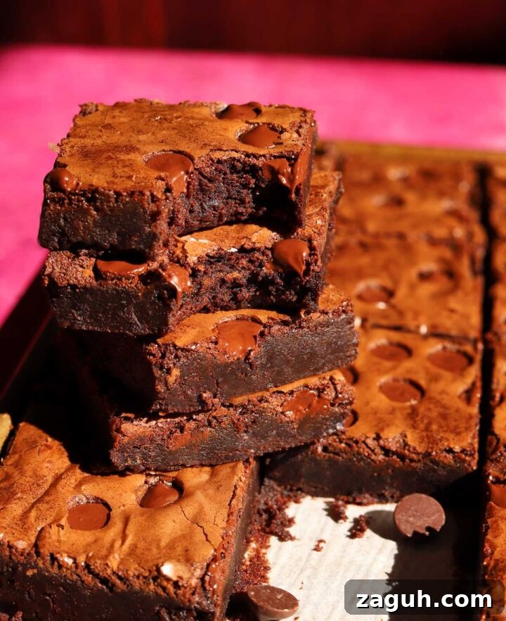 Chewy Sheet-Pan Brownies: One-Pan Recipe for Fudgy Bars 9 stack of sheet pan brownies with bite
