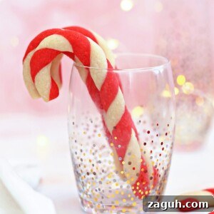 DIY Oreo Cookie Christmas Ornaments: Festive Homemade Ideas 10 Candy Cane Cookies standing up in a clear glass with gold and silver dot accents.